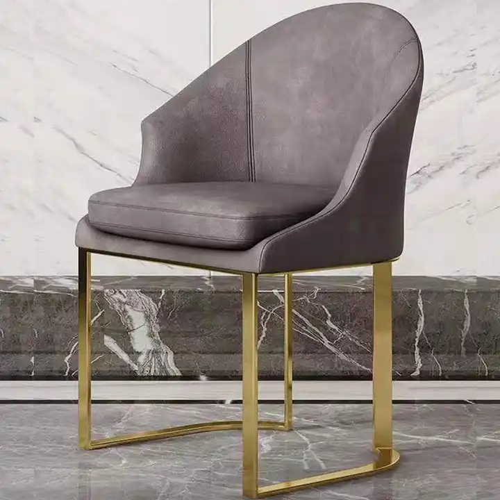 szare welurowe krzesło ze złota postawą